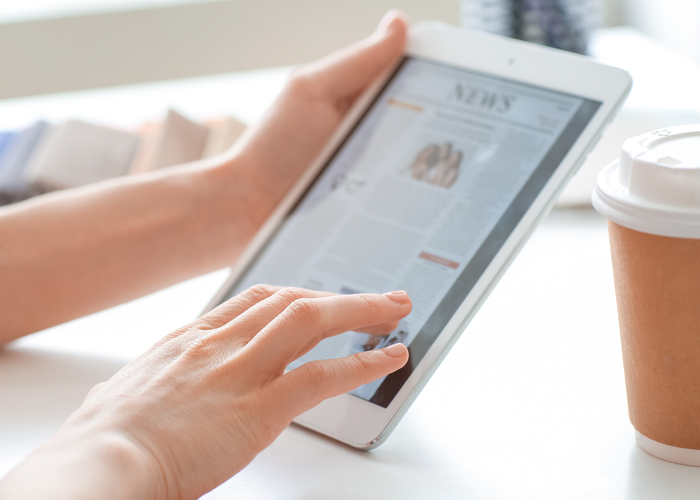 person reading news on a tablet
